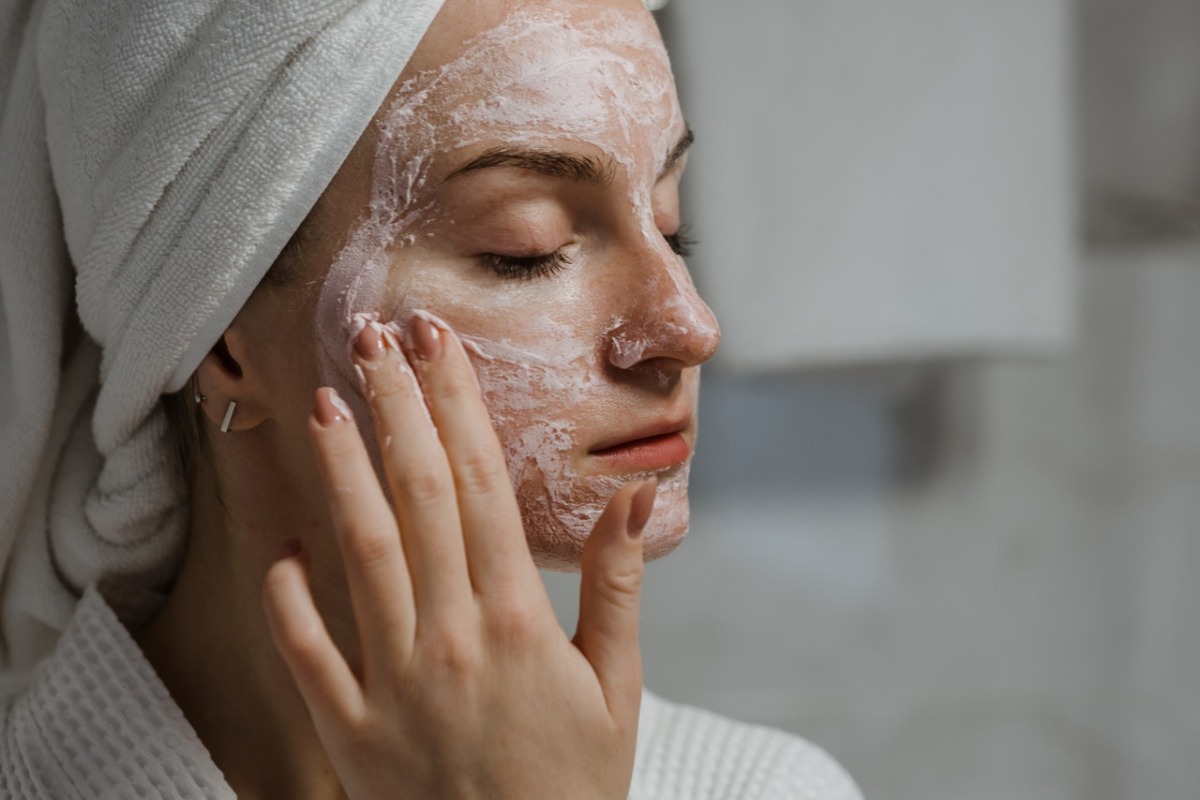 woman applying products to her face