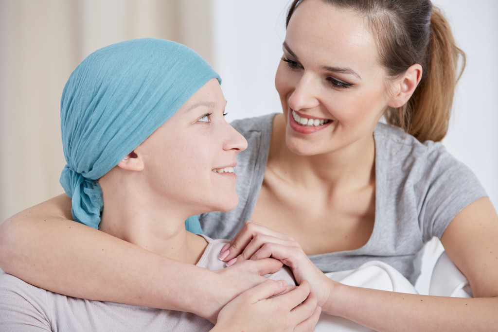 A woman comforting a friend who's a cancer patient