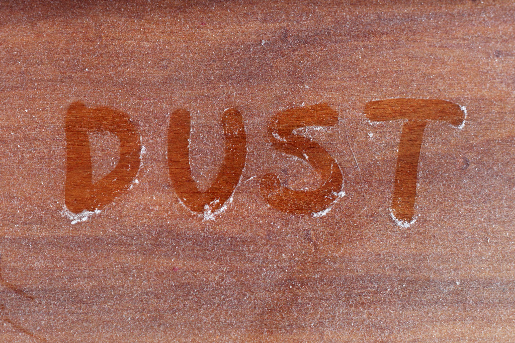 Dust written on a dust layer on furniture