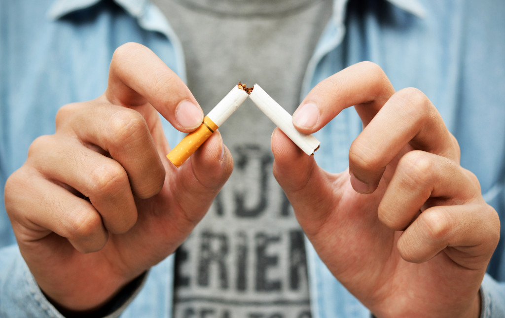 man breaking a cigarette