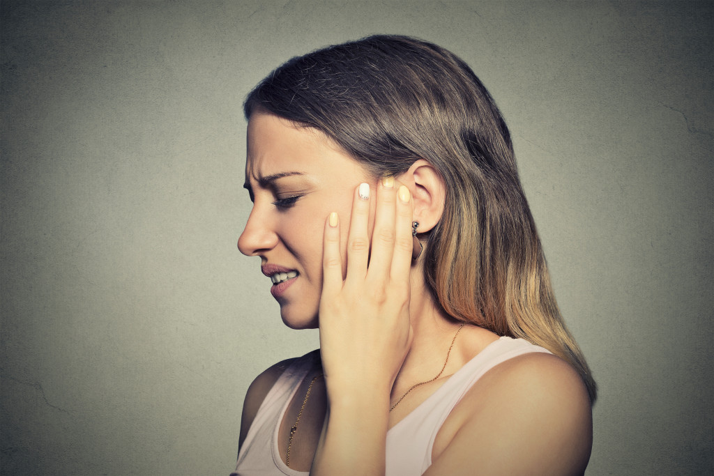 young woman having ear pain
