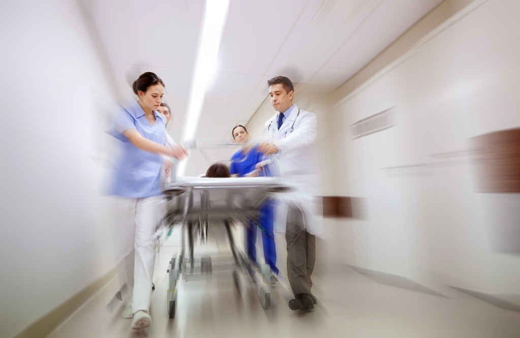 hospital workers in an hospital emergency with rushing effects
