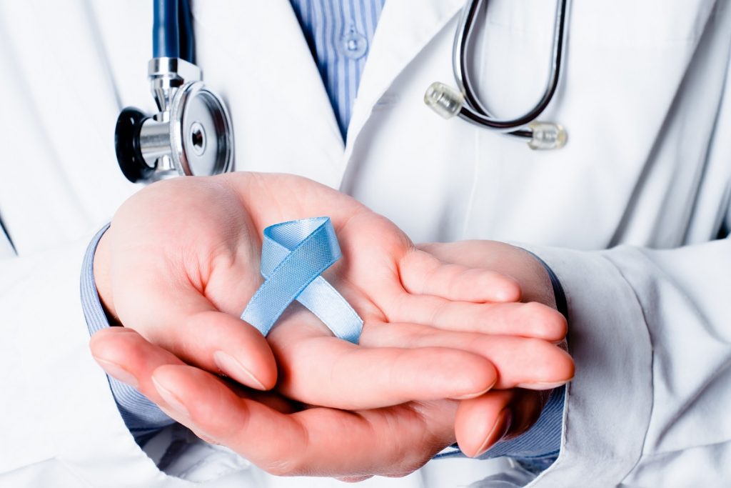 doctor with blue ribbon on hand