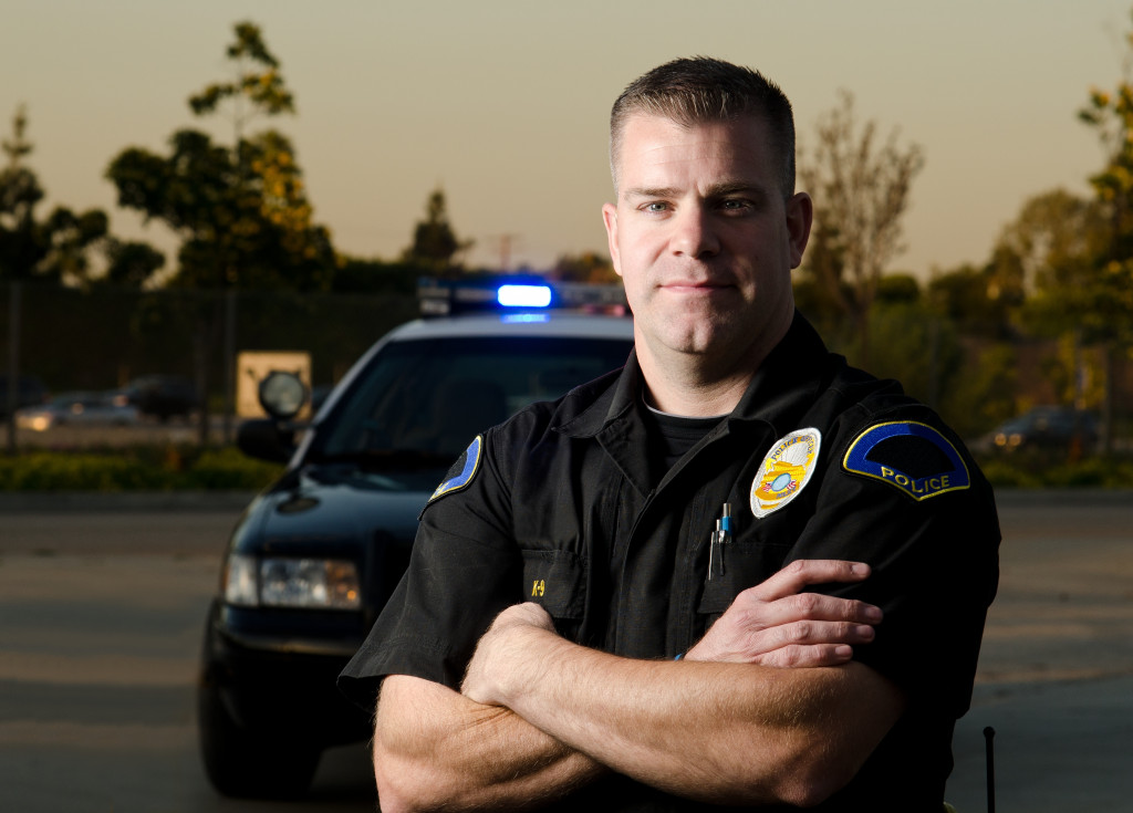 a male police officer posing for the camera